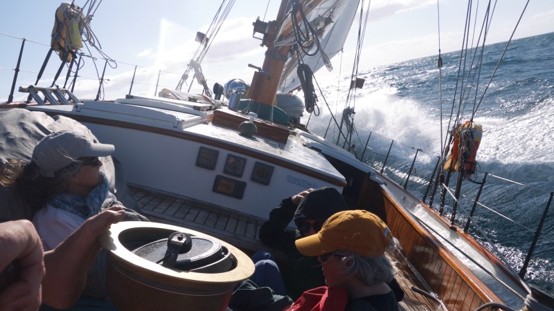 People onboard on boat with massive waves
